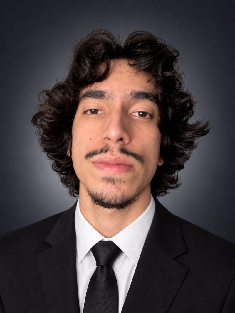 Masoud Kabir, founder of Xeaura, in a dark suit against a grey studio backdrop.